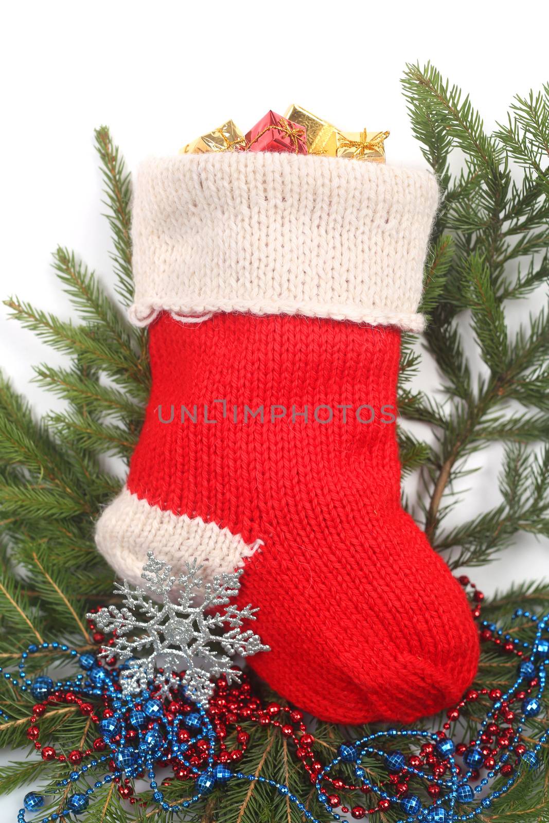 Red Christmas sock with gifts isolated on white background