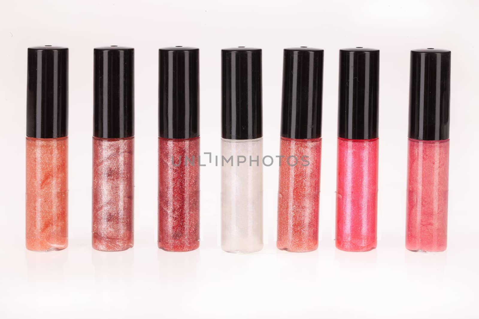 Little bottles with enamel on an isolated studio background