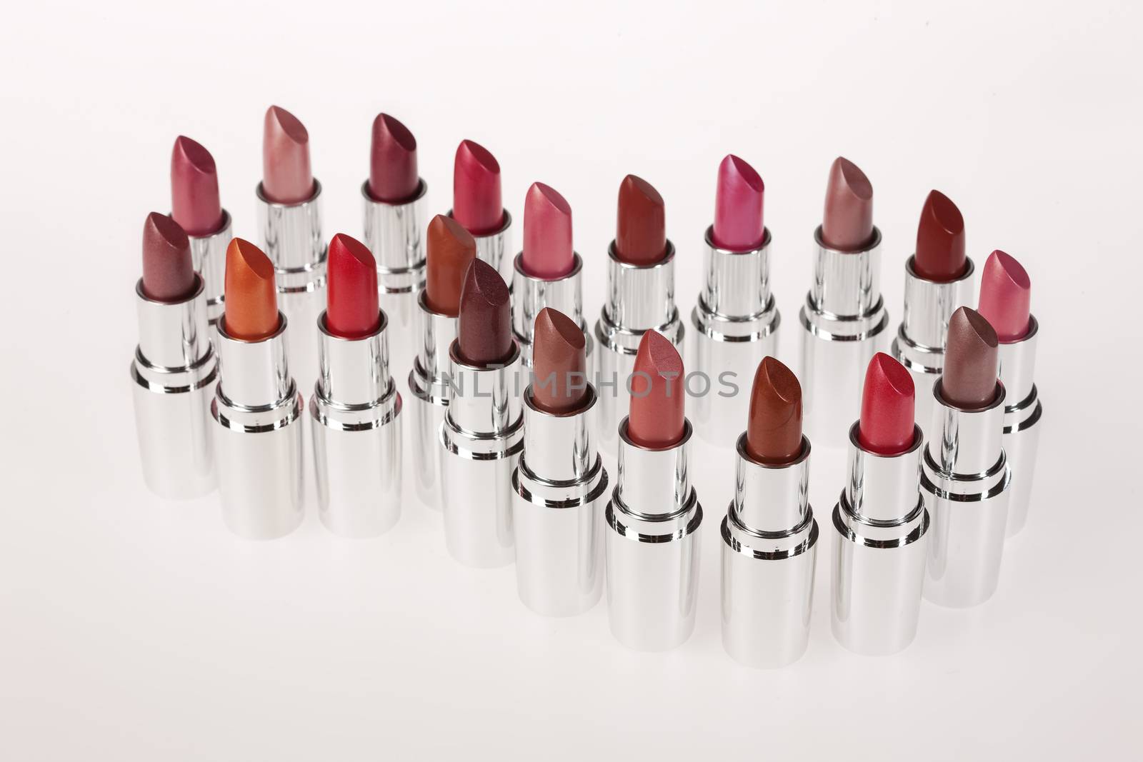 Tubes with different kinds of lipstick on studio background