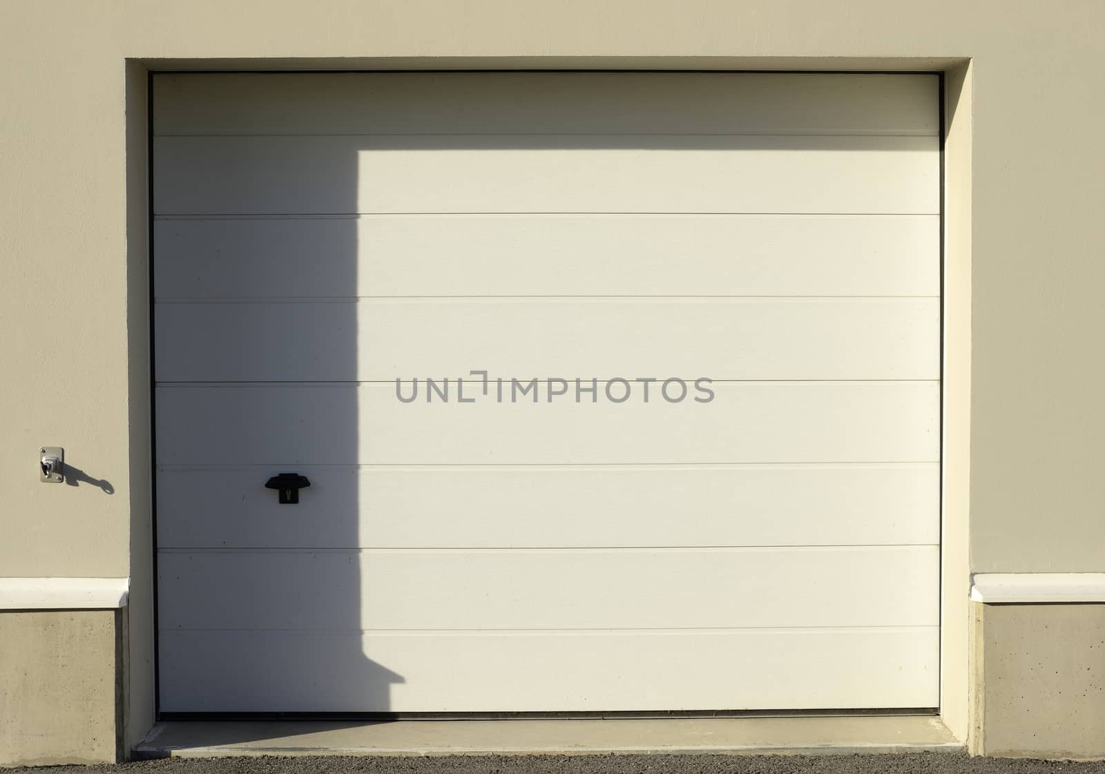 Garage door, half in shadow, half in sunshine.