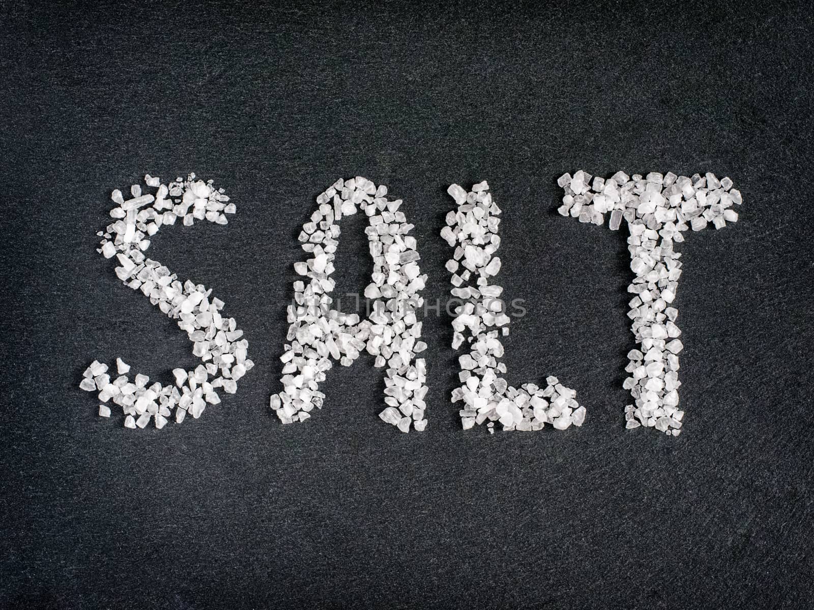 Salt word from coarse sea salt on stone by fascinadora