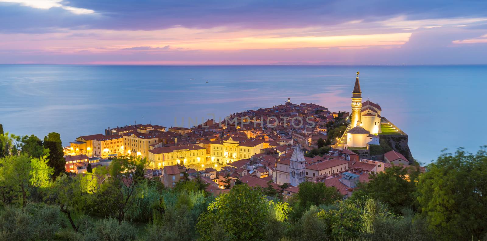 Romantic colorful sunset over picturesque old costal town Piran, Slovenia. Senic panoramic view.