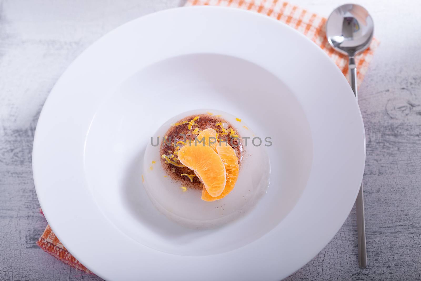 Coconut panna cotta with slices of oranges. 