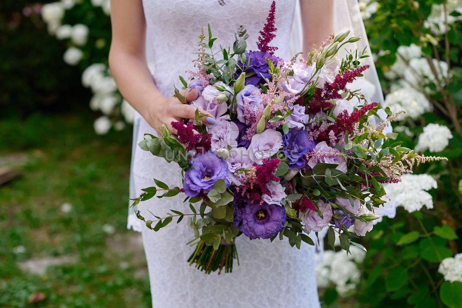 bride holding a beautiful bridal bouquet on walk