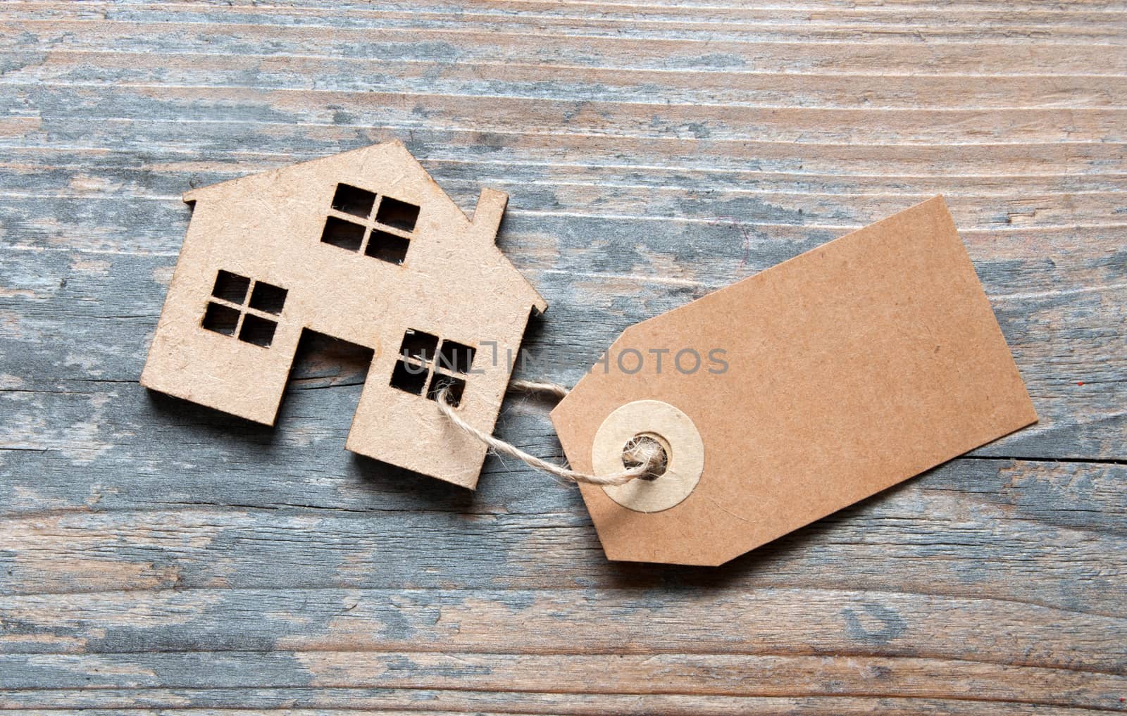 Blank label attached to miniature house 