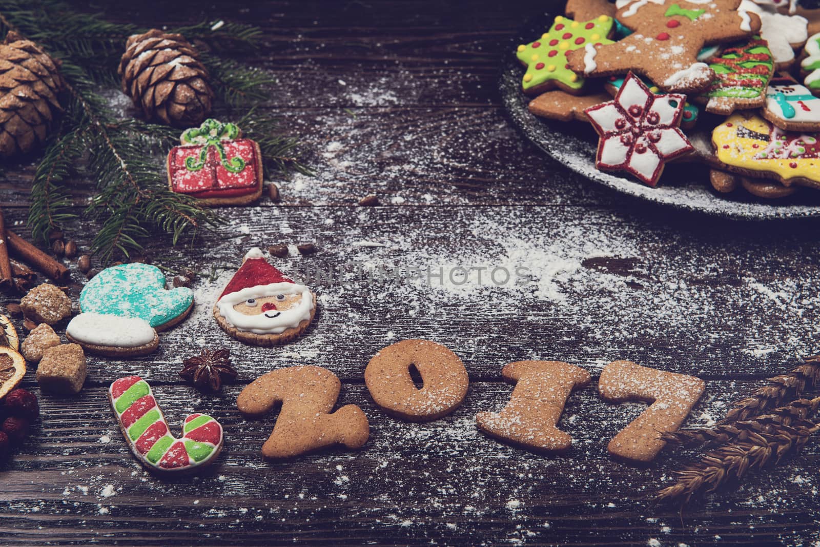 Different ginger cookies for new 2017 year holiday on wooden background, xmas theme