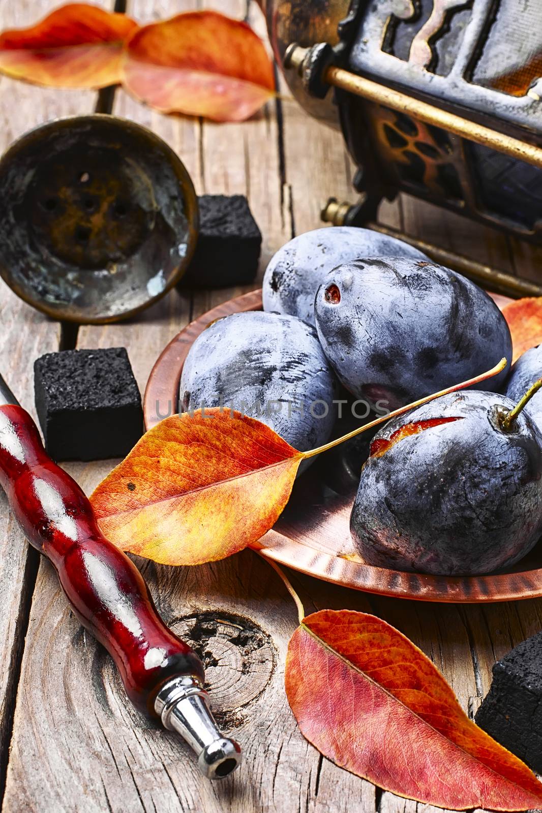 Smoking hookah accessories and tobacco with taste of autumn plums