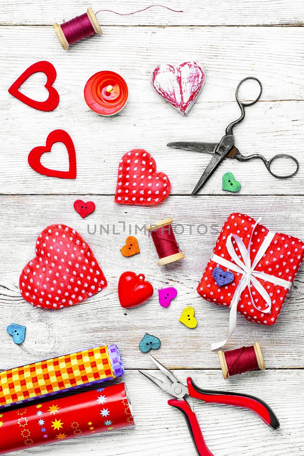 Packing holiday gifts for Valentine's day.Thread,button and symbolic heart.