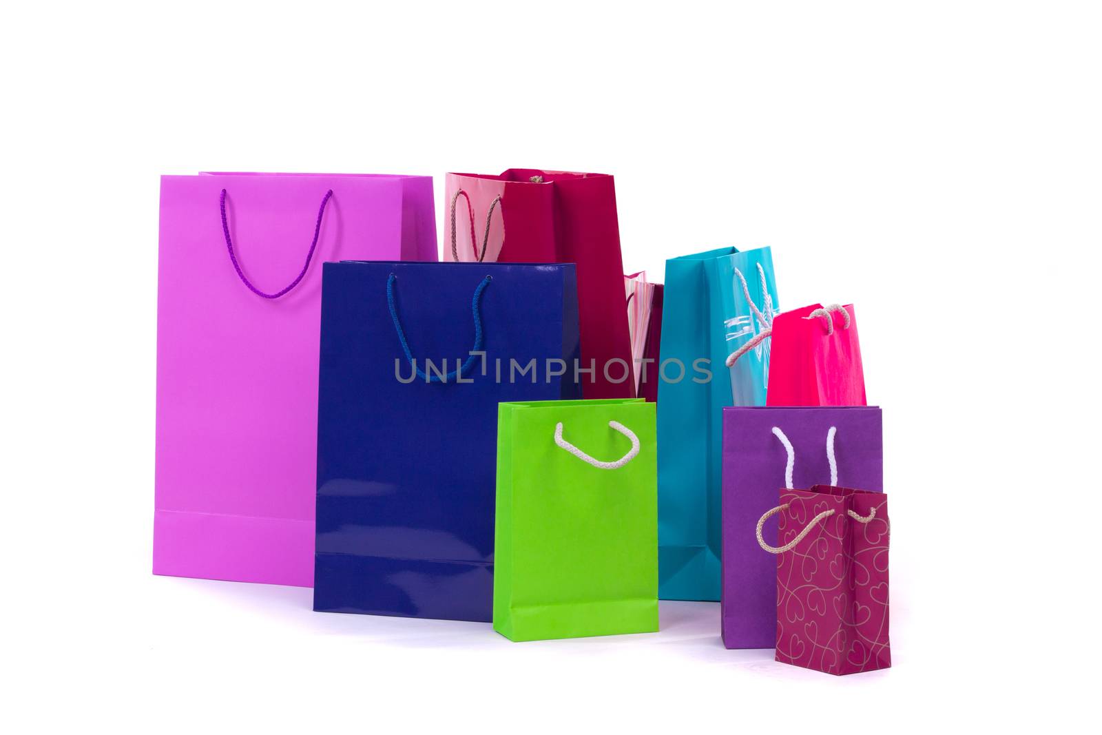 Composition of colourful and bright shopping packages for gifts and presents isolated on white