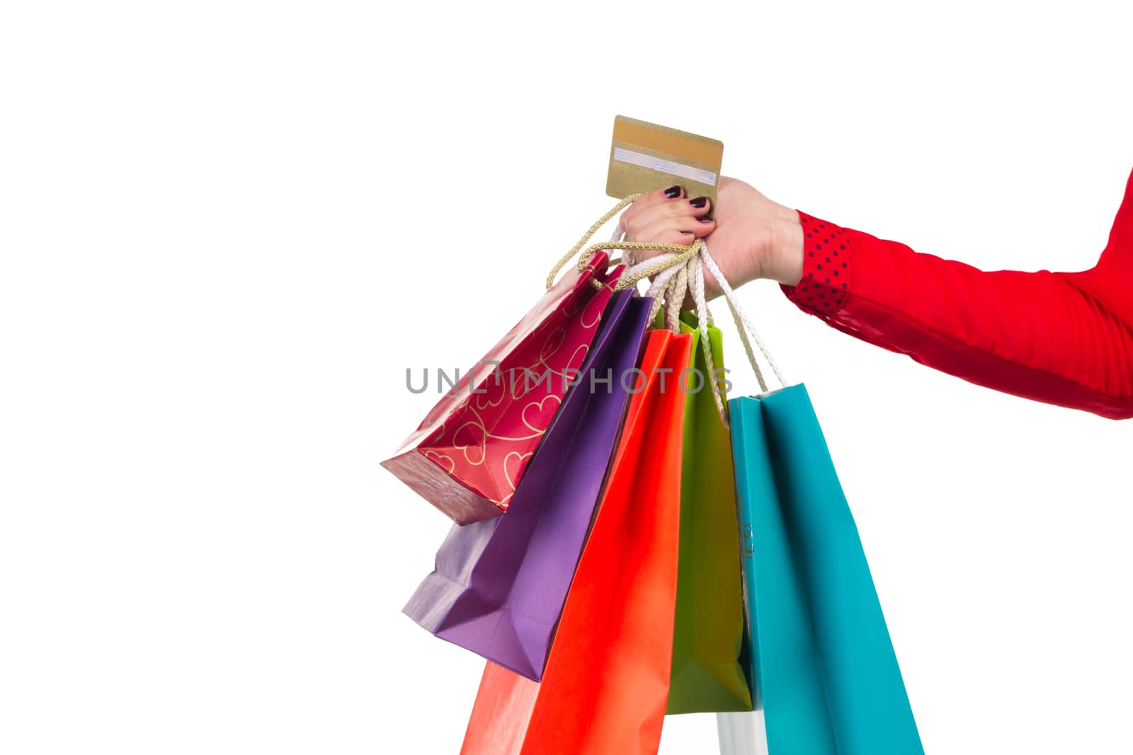 Colourful and bright shopping paper packages and banking card in female right hand