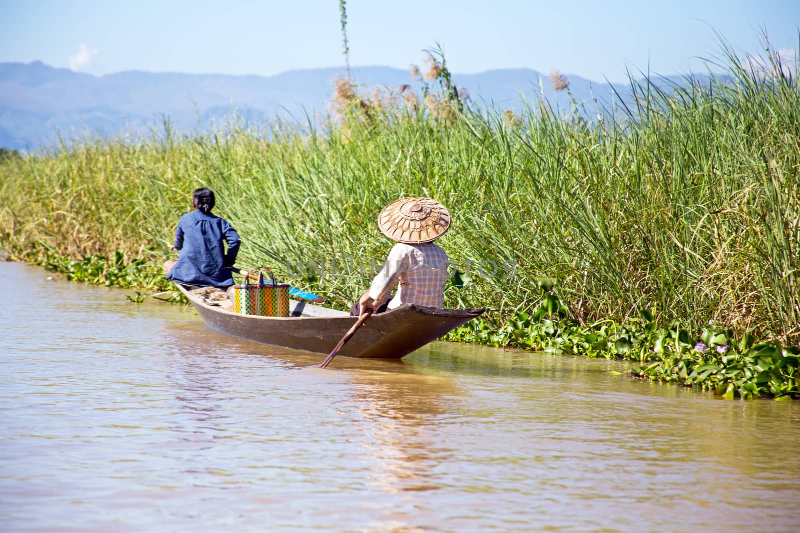 Inthas travel on boat in Inle, Myanmar. Travel by boat is the major transportation mean both local and tourists in Inle lake.
