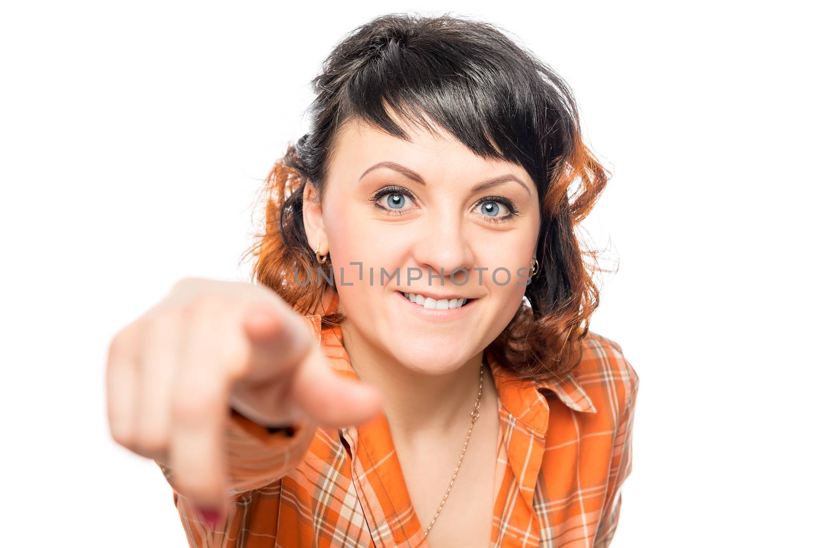 Positive beautiful woman shows a finger at the camera on a white background