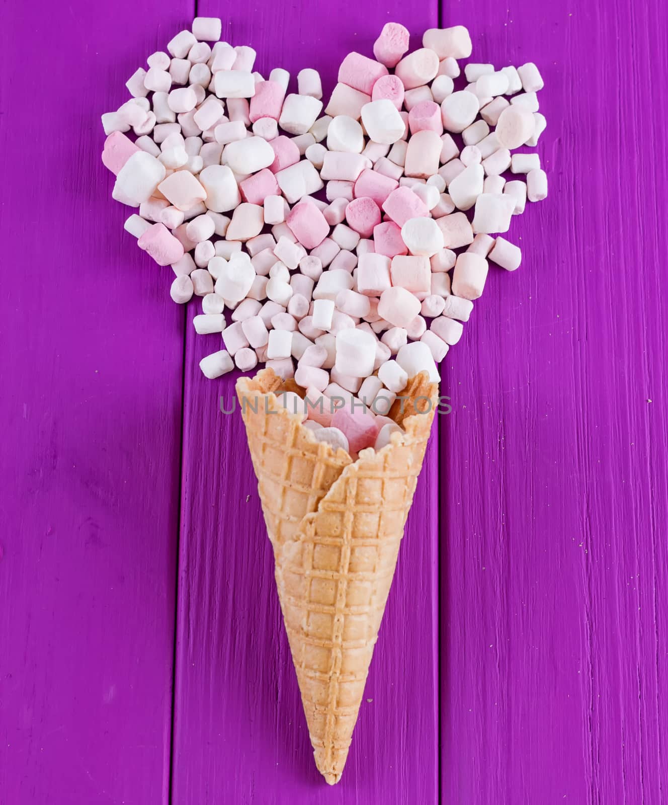 Marshmallows heart and waffle cones on a purple background