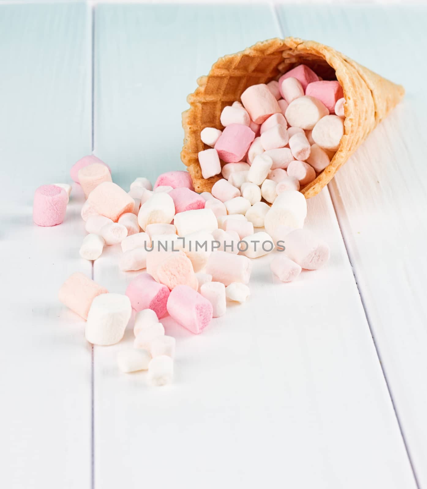 Dessert in ice cream cone on gray background on a white background