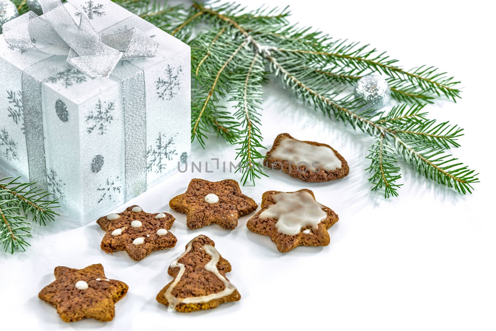 Gingerbreads with icing next to Christmas decorations