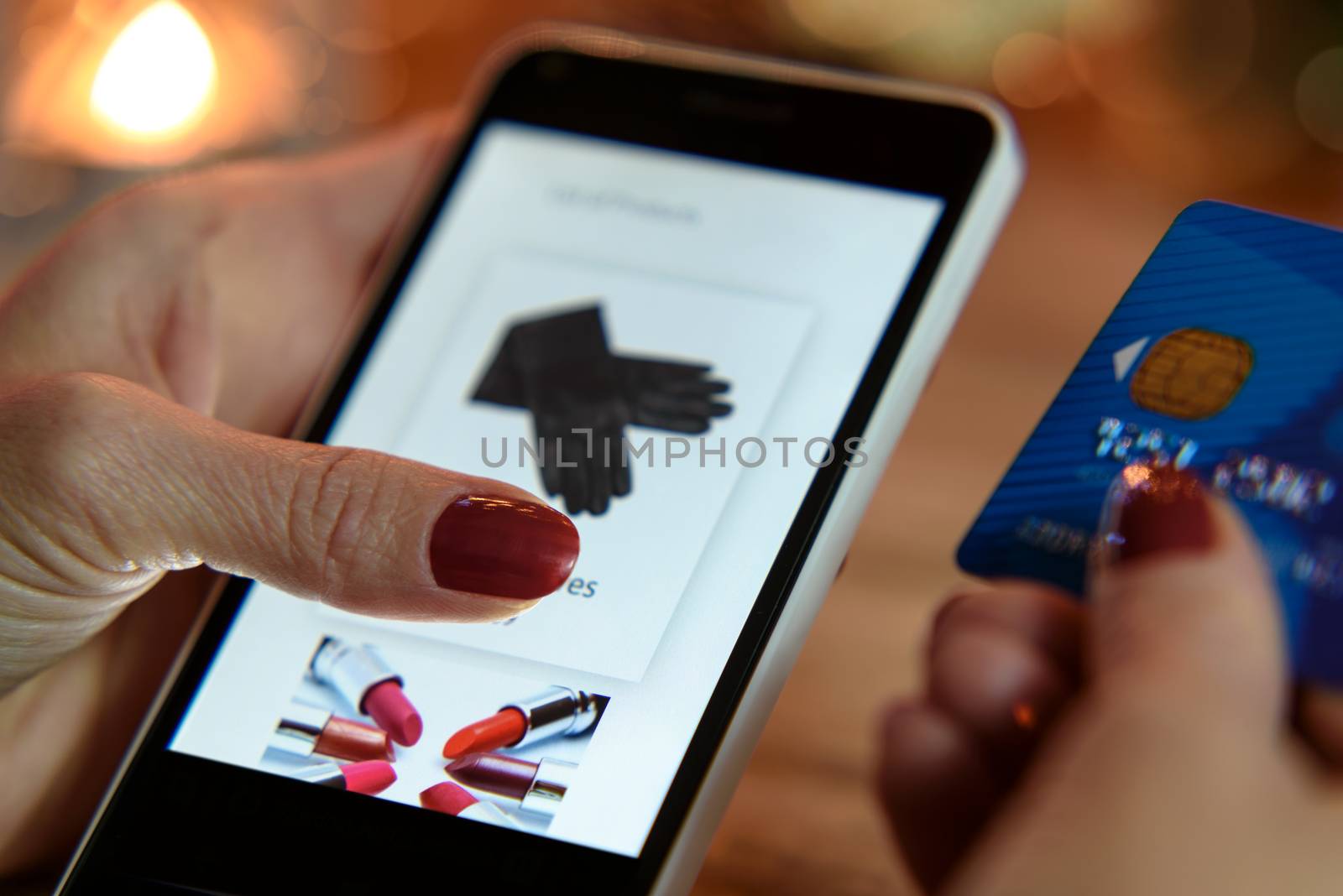 Modern Woman makes shopping via smartphone and a credit card in the e-store