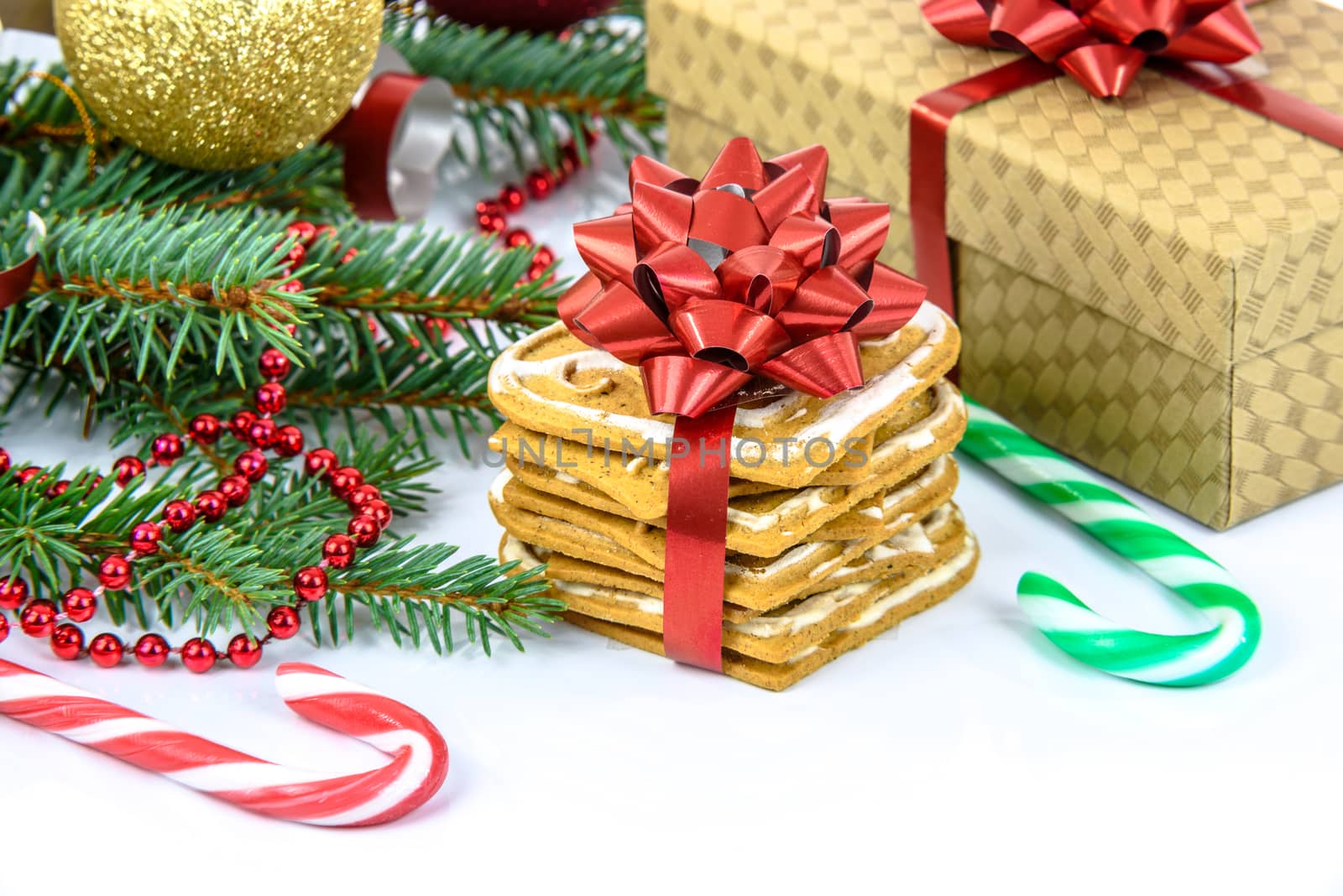 Ginger cookies decorated with a red ribbon and lollipops with a Christmas decoration isolated on white background