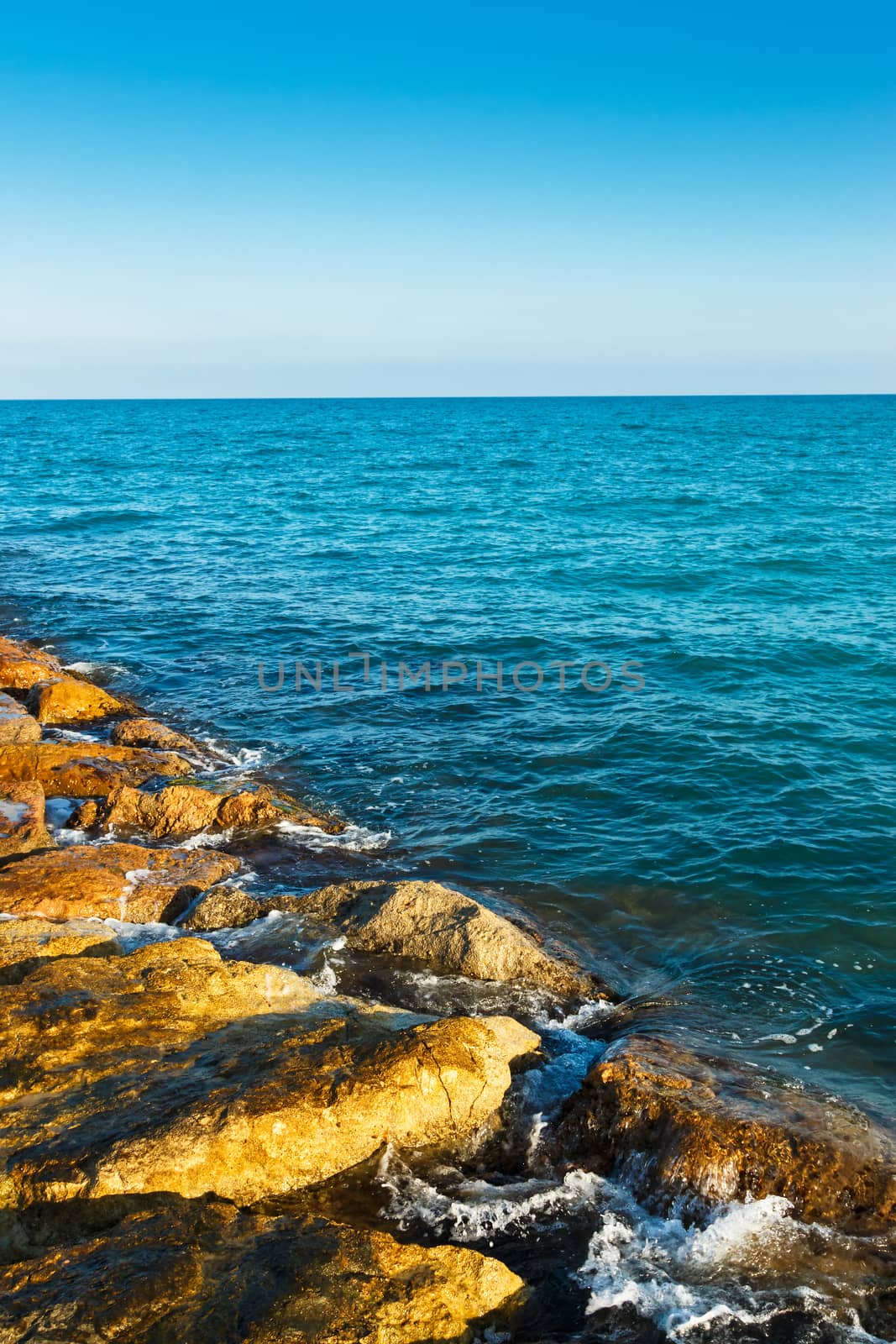 Stones of the sea breakwater. Vertical image.