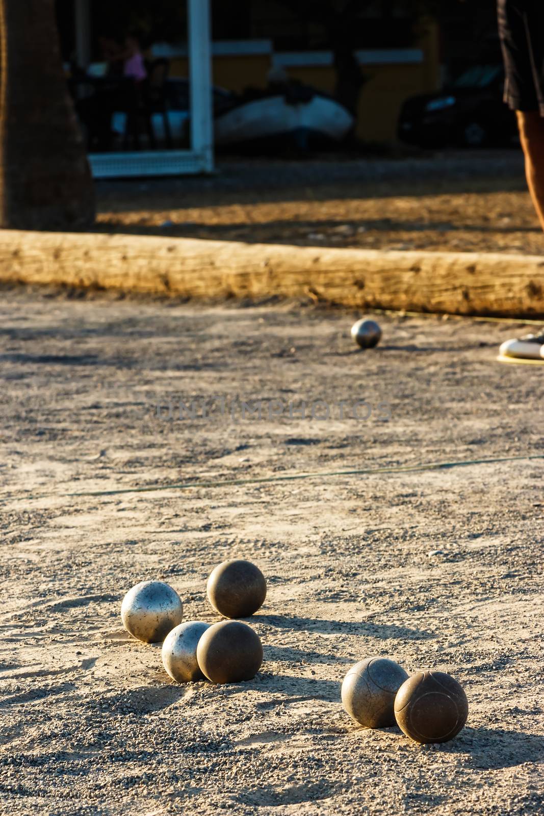 Game of petanque on the ground. Verical image.