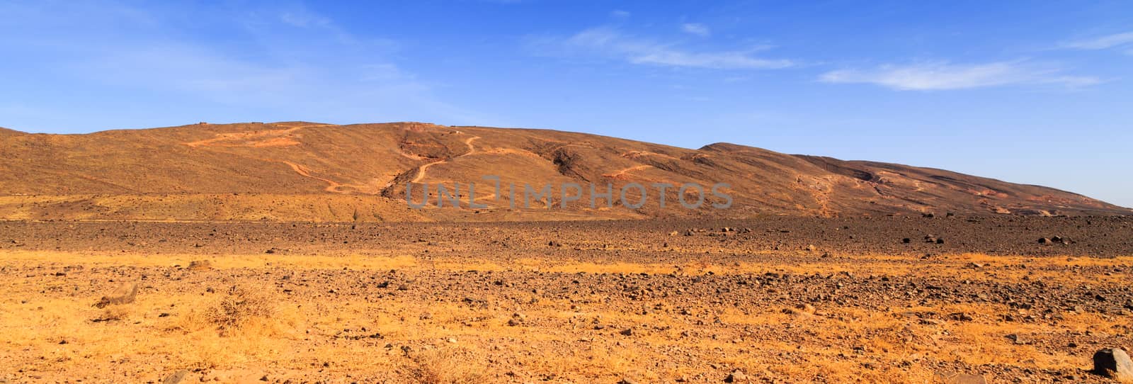 Beautiful Moroccan Mountain landscape in desert with blue sky by pixinoo