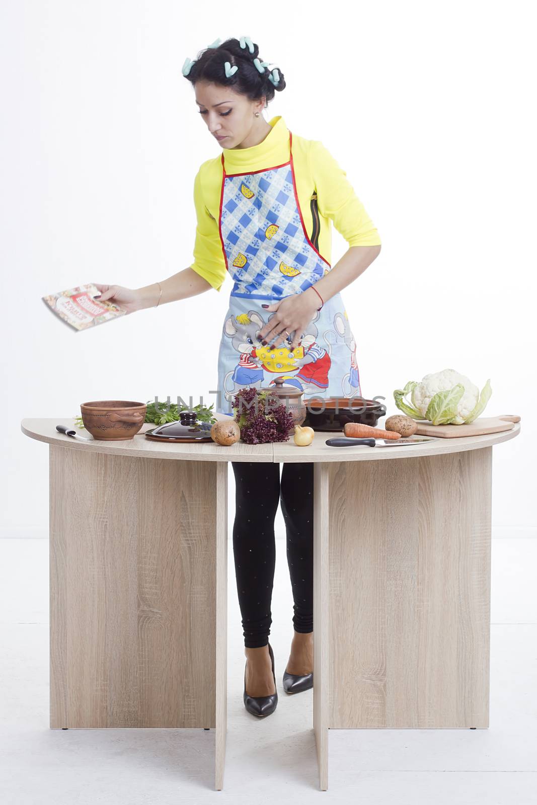 Housewife is preparing in the kitchen on a white background