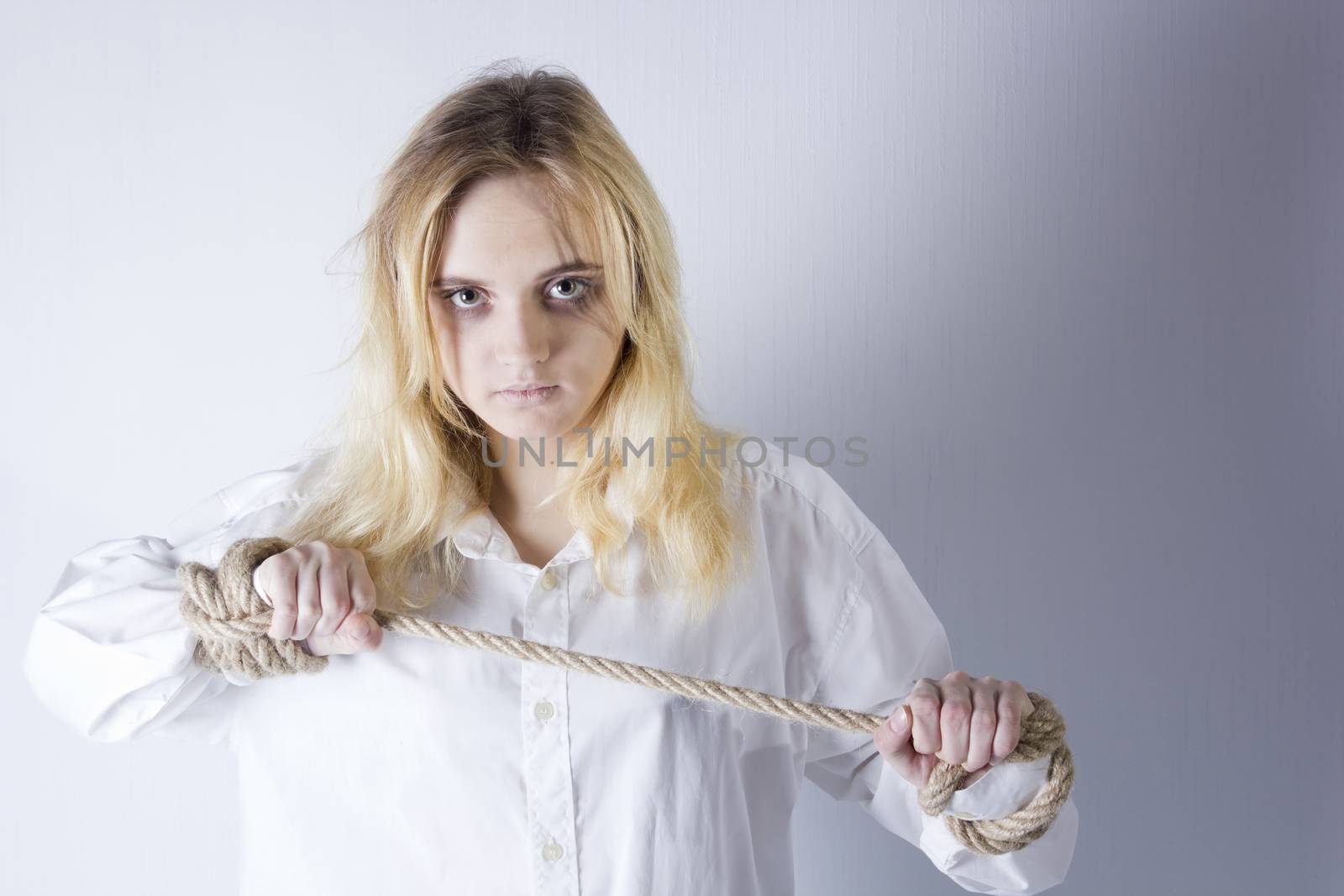 Crazy kind of young girl with hands tied with rope