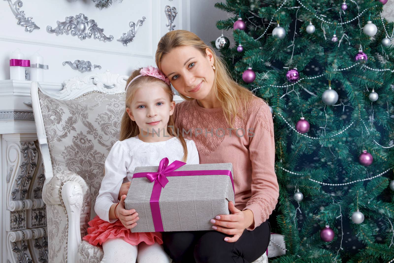 Mother and daughter holding Christmas gift