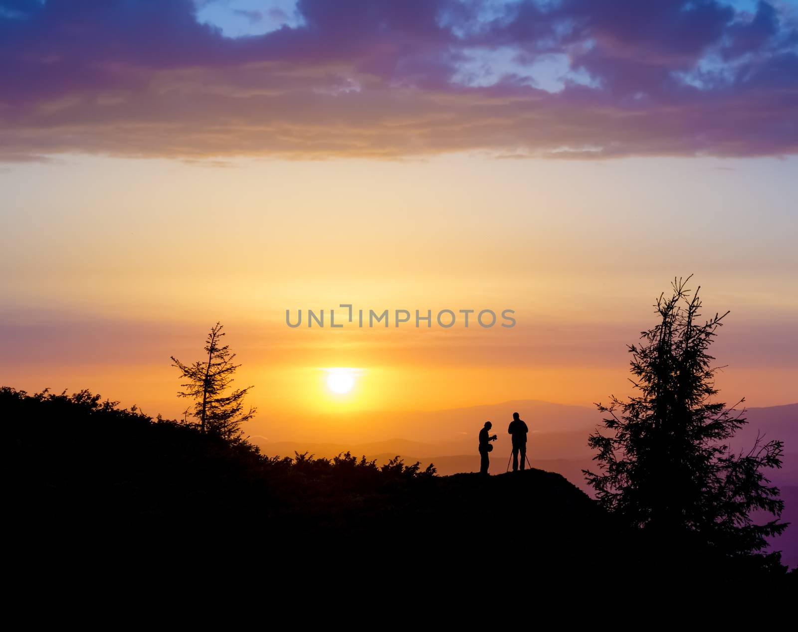 Sunset behind two People by oleksandrmazur