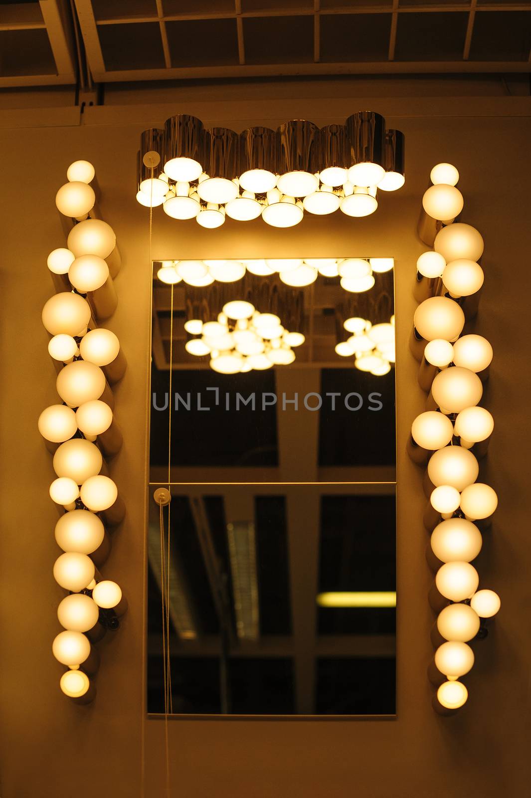 on the sides of mirror in hallway.