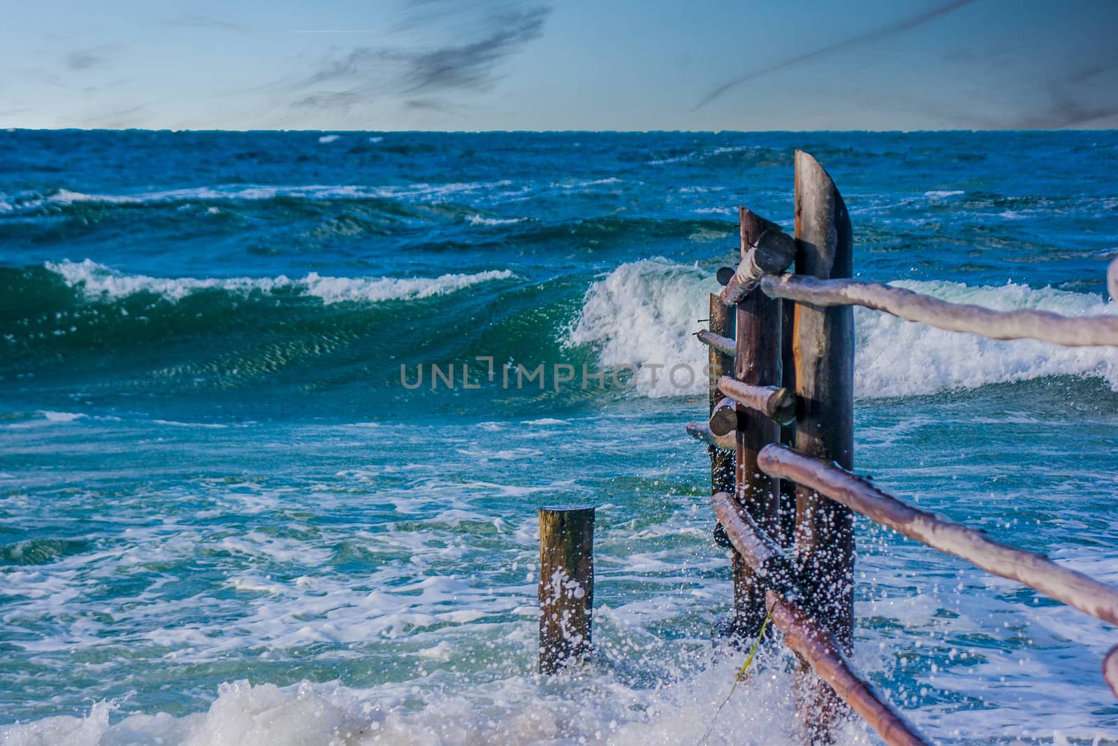 Breaking waves on an old fence in the eas sea in Germany