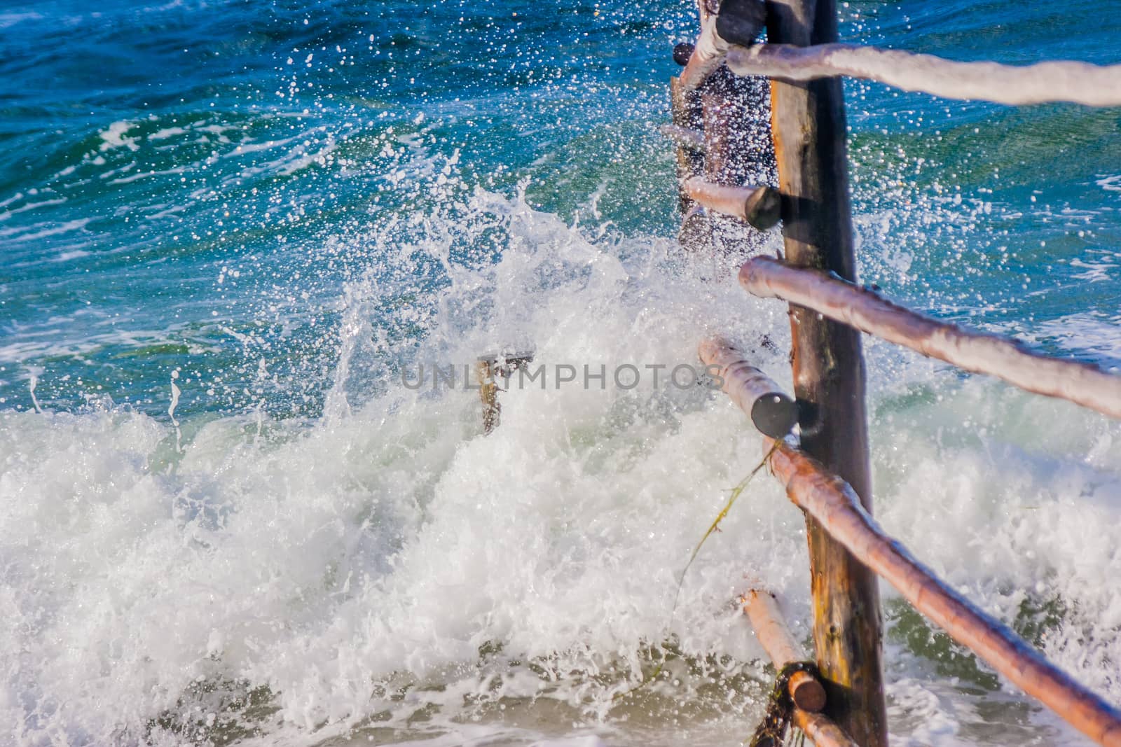Breaking waves on an old fence in the eas sea in Germany