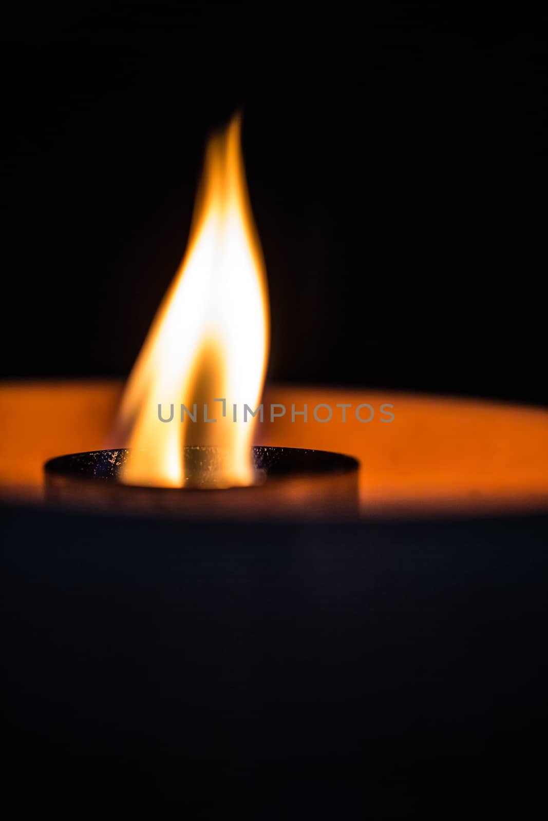 A candle flickering in the dark