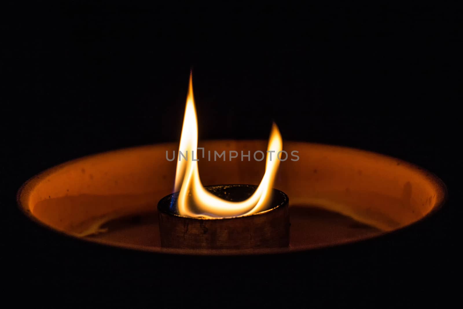 A candle flickering in the dark