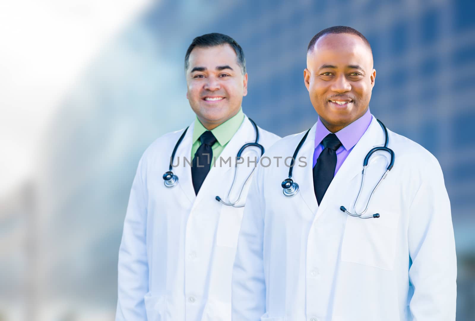 Handsome African American and Hispanic Male Doctors Outside of Hospital Building.