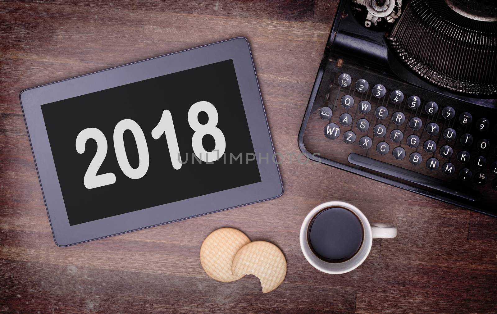 Tablet touch computer gadget on wooden table, vintage look - 2018