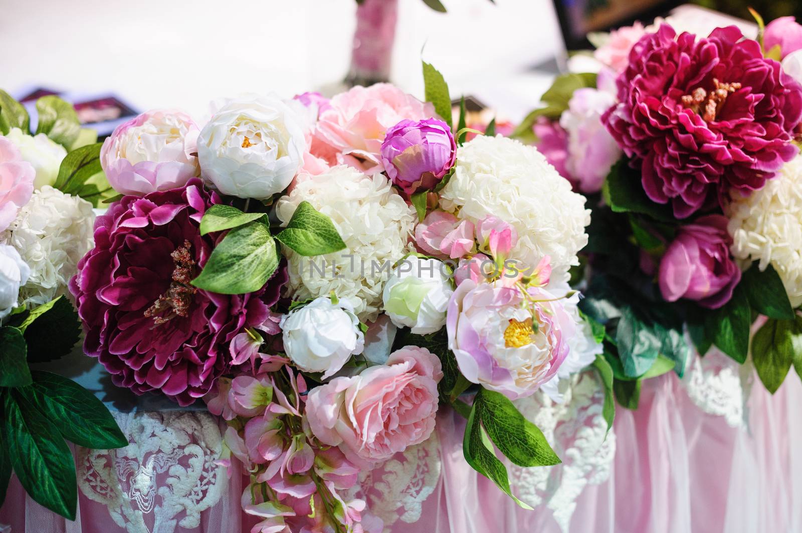 Flower decor on wedding table bride and groom in restaurant.