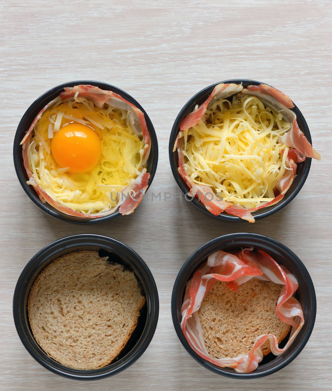 fried eggs, bread and bacon in a porcelain pan