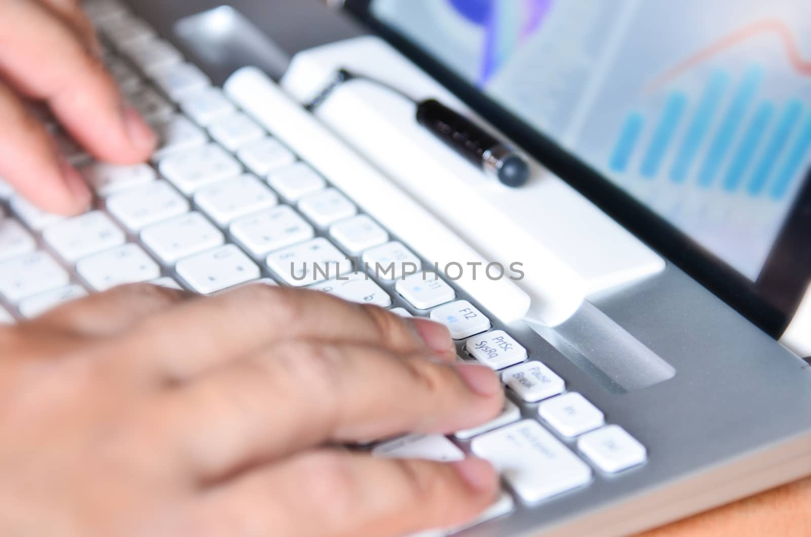 Businessman hands busy using laptop at office desk