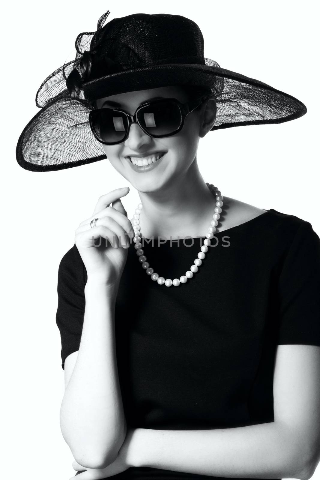 Portrait of a beautiful young woman in retro style in an elegant black hat isolated on white background