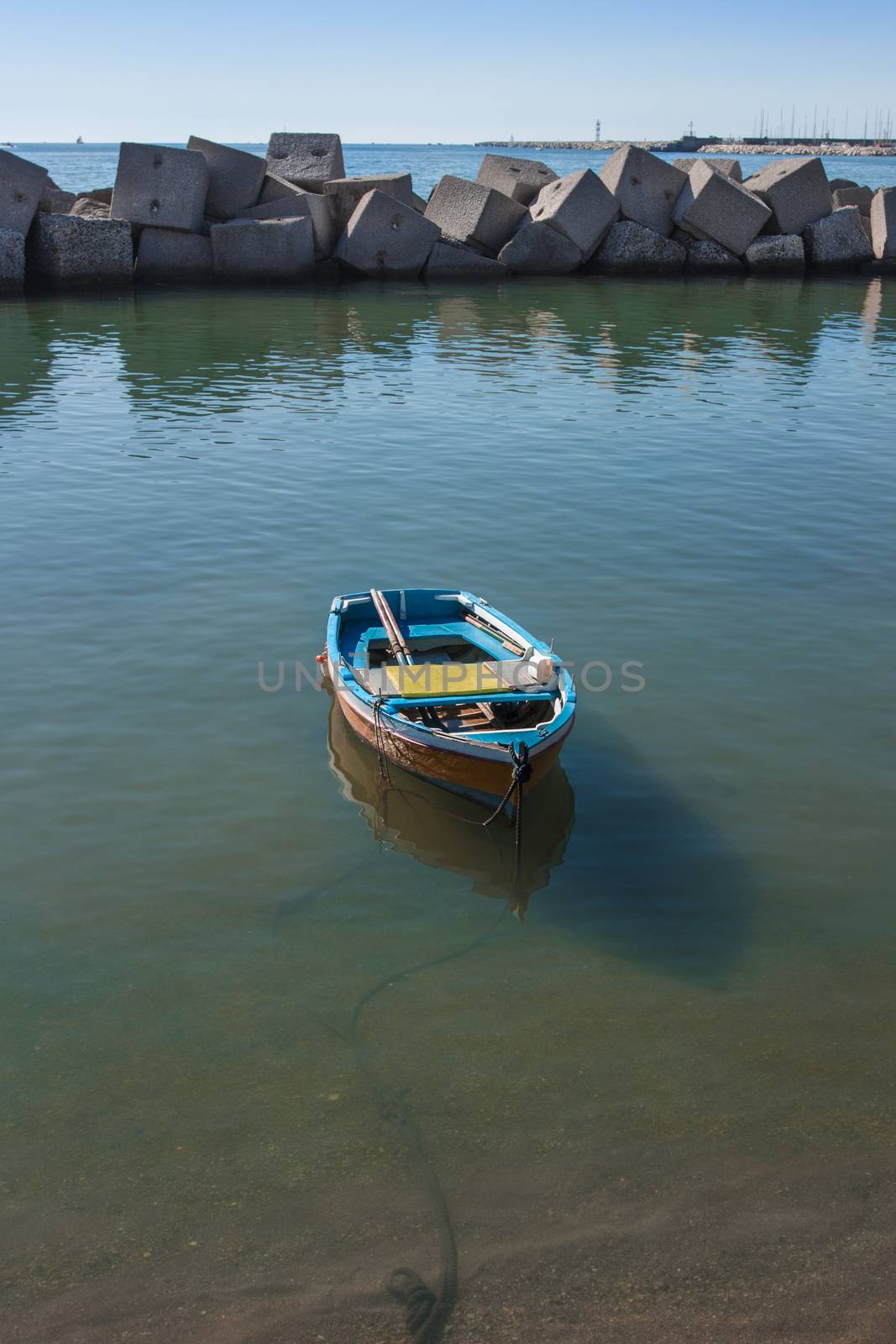 Boat moored in the port of Salerno in a sea green waters. Salerno destination for tourism and culture