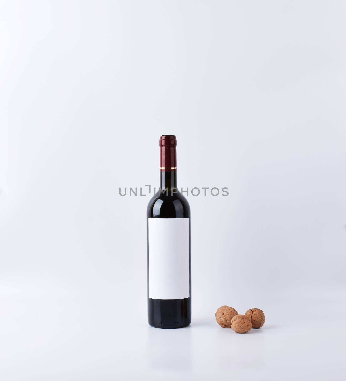 Mockup wine bottle with three nuts isolated by Kazimirko