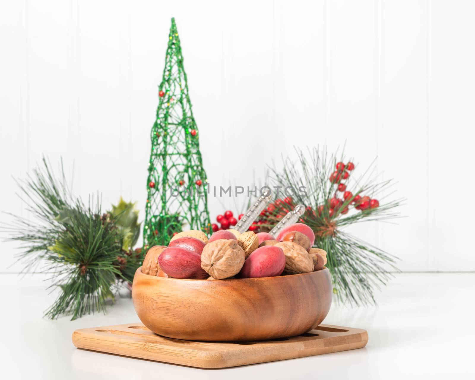 Bowl of whole mixed nuts with a seasonal background.