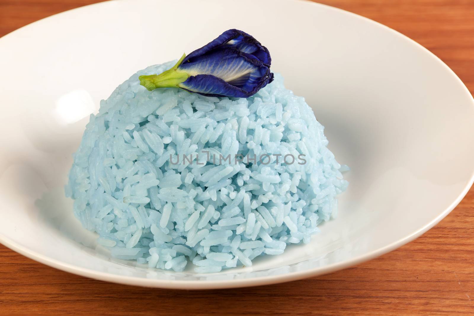 Blue Rice made cooking from Butterfly Pea flower (Clitoria ternatea L) in white dish. Rice has a colorful and fragrant flowers and good for health.