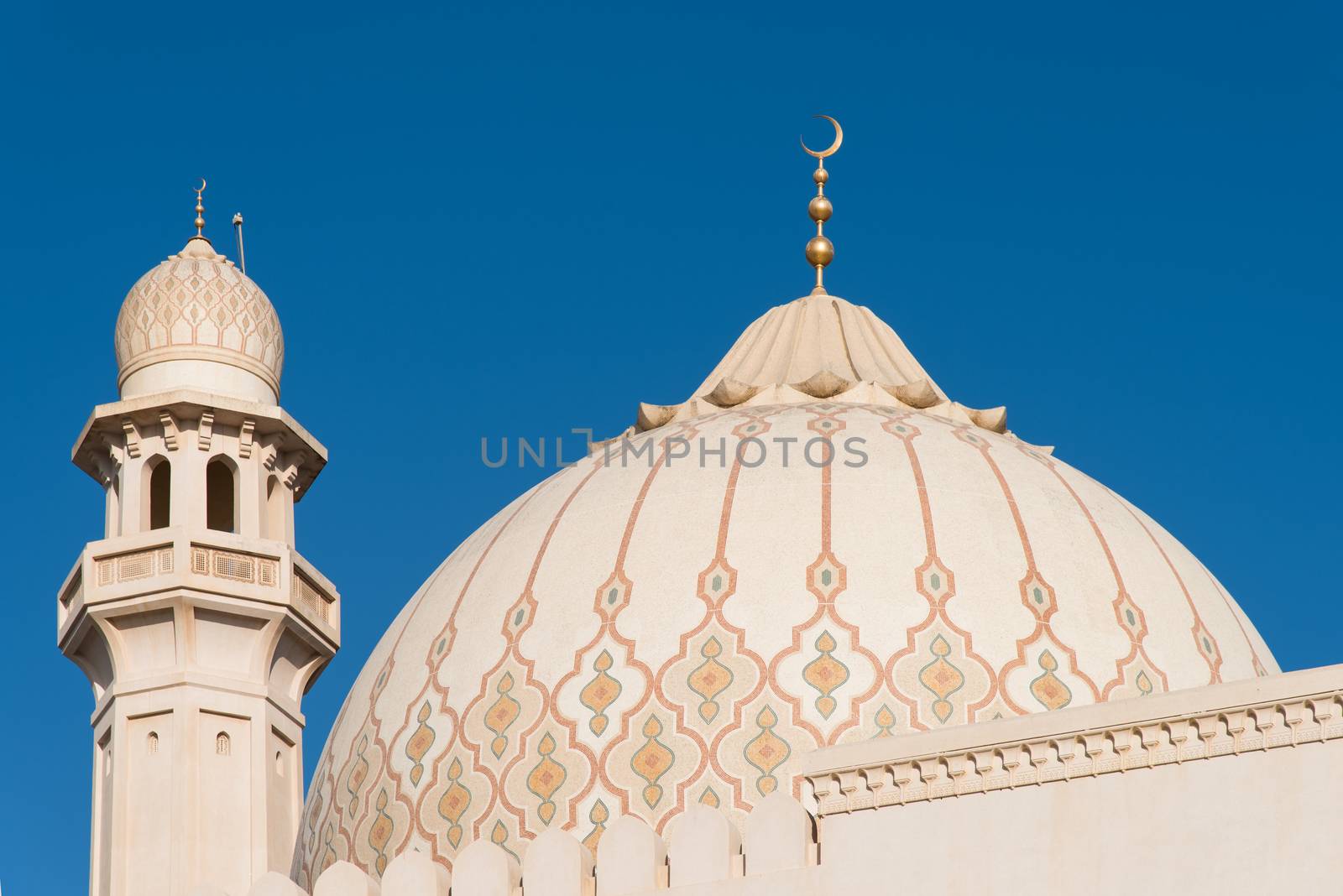 The dome and one of the minarets of the Sultan Qaboos Grand Mosque in Salalah, Dhofar Region of Oman.