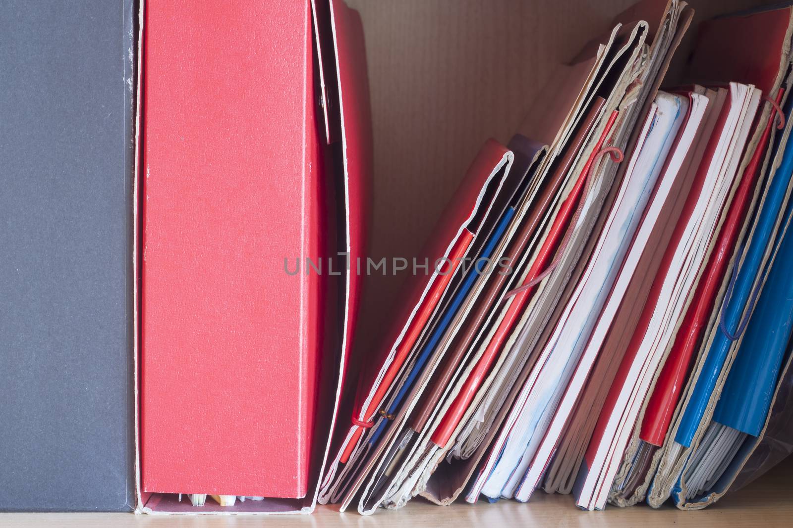Stacks of colored folders with documents on the desktop