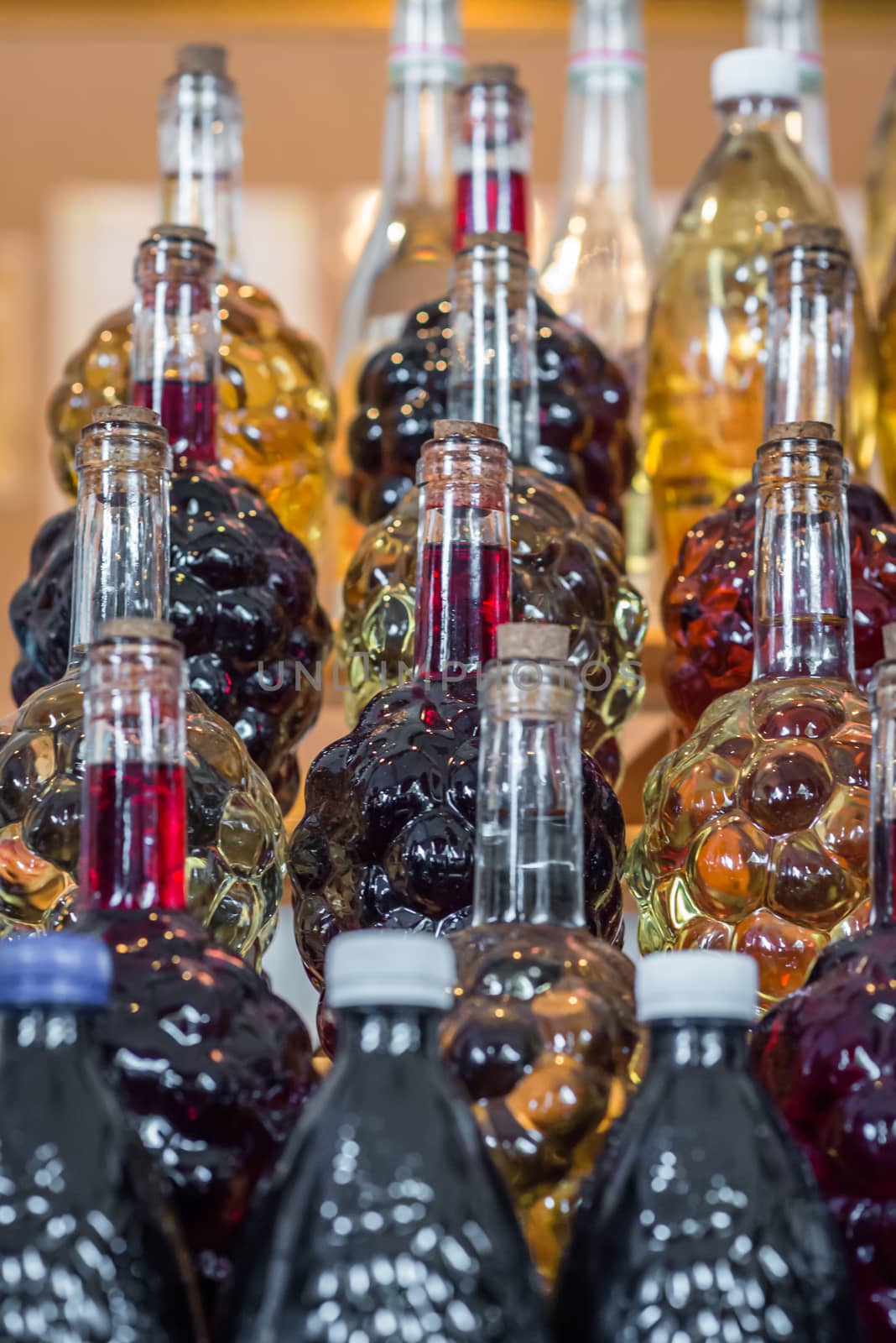 set of bottle in the form of grapes are filled with wine