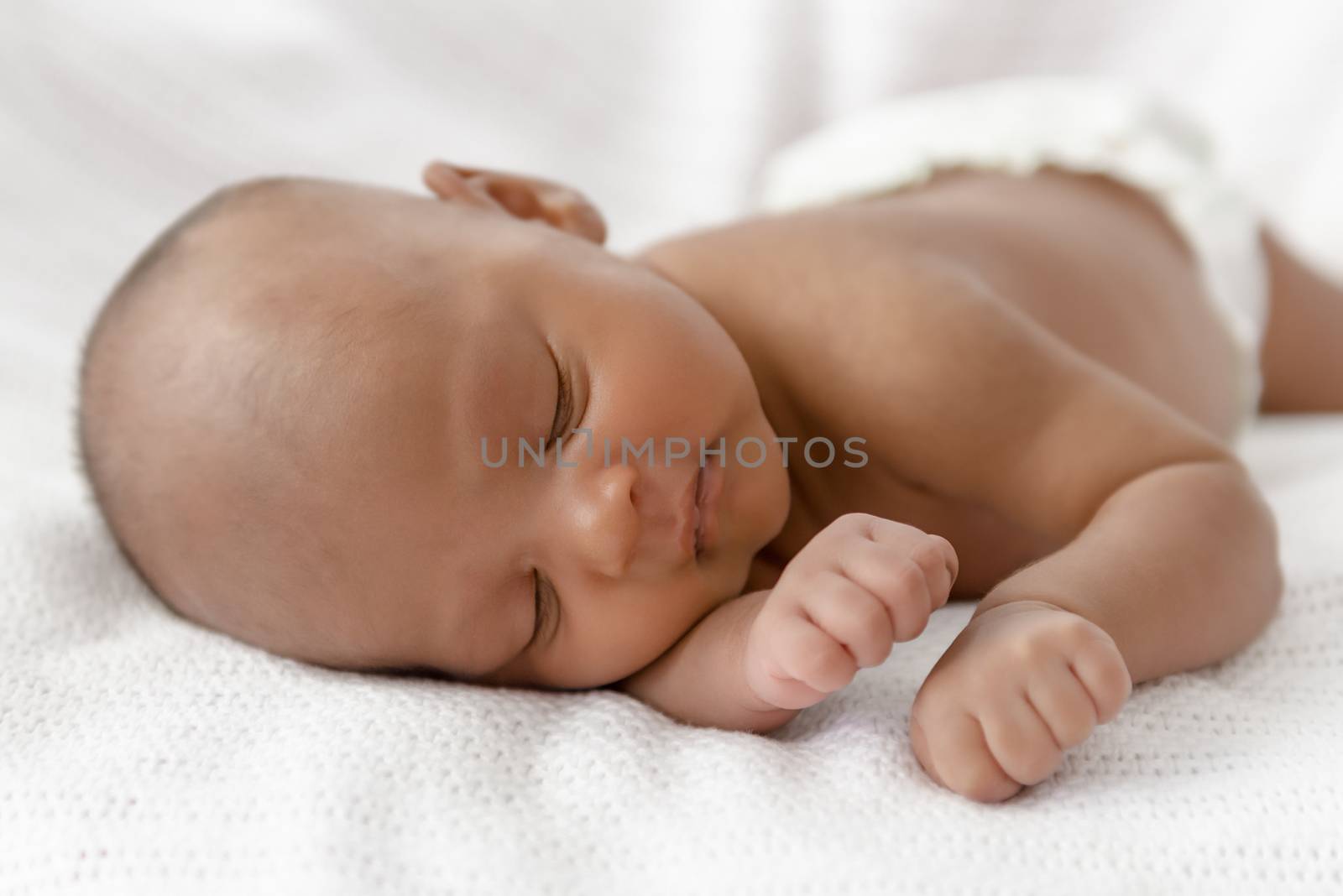 Three weeks old baby sleeping on white blanket cute infant newborn lying down close up shot eyes closed by Altinosmanaj