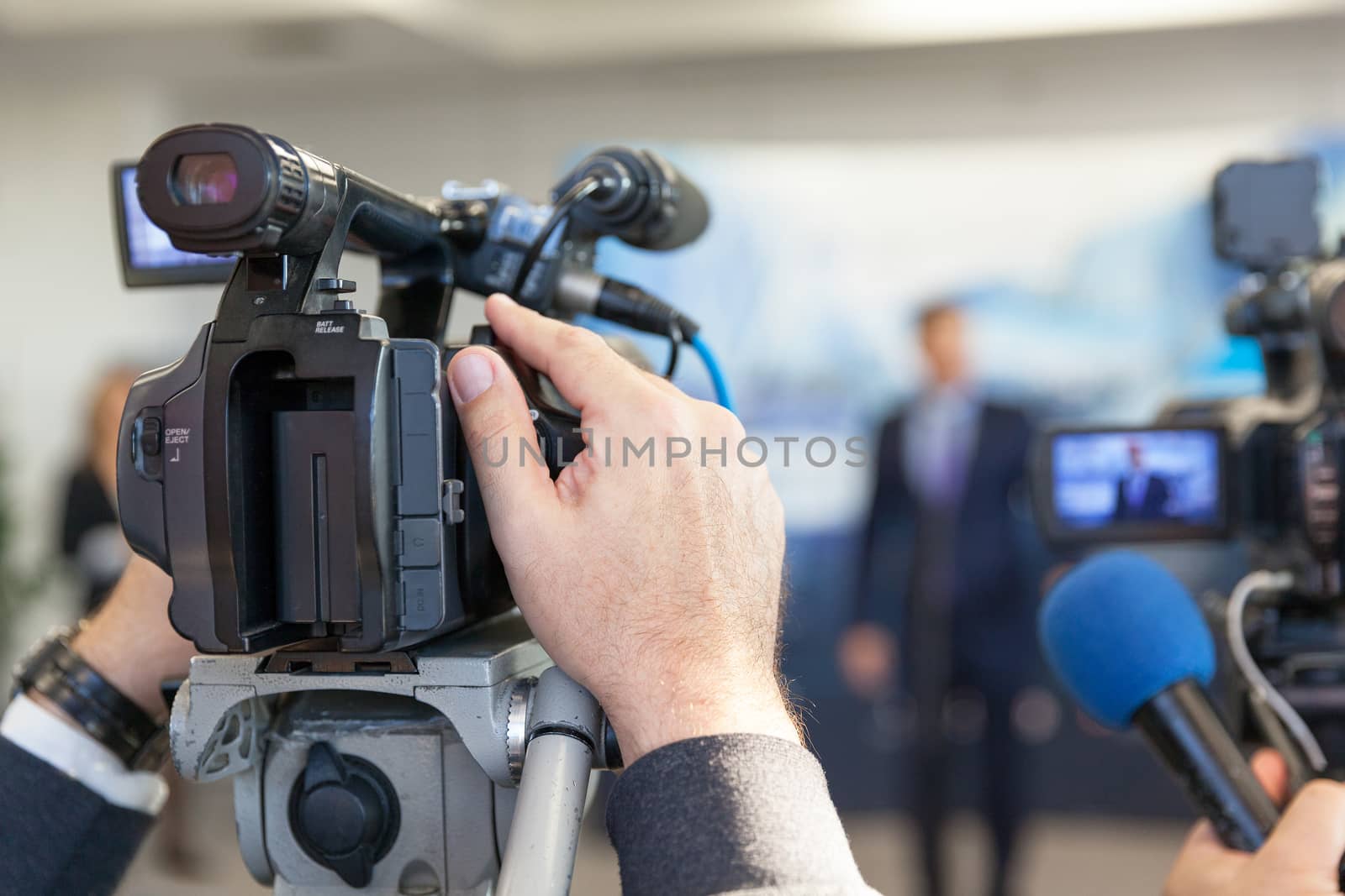Blurred spokesman at press conference by wellphoto