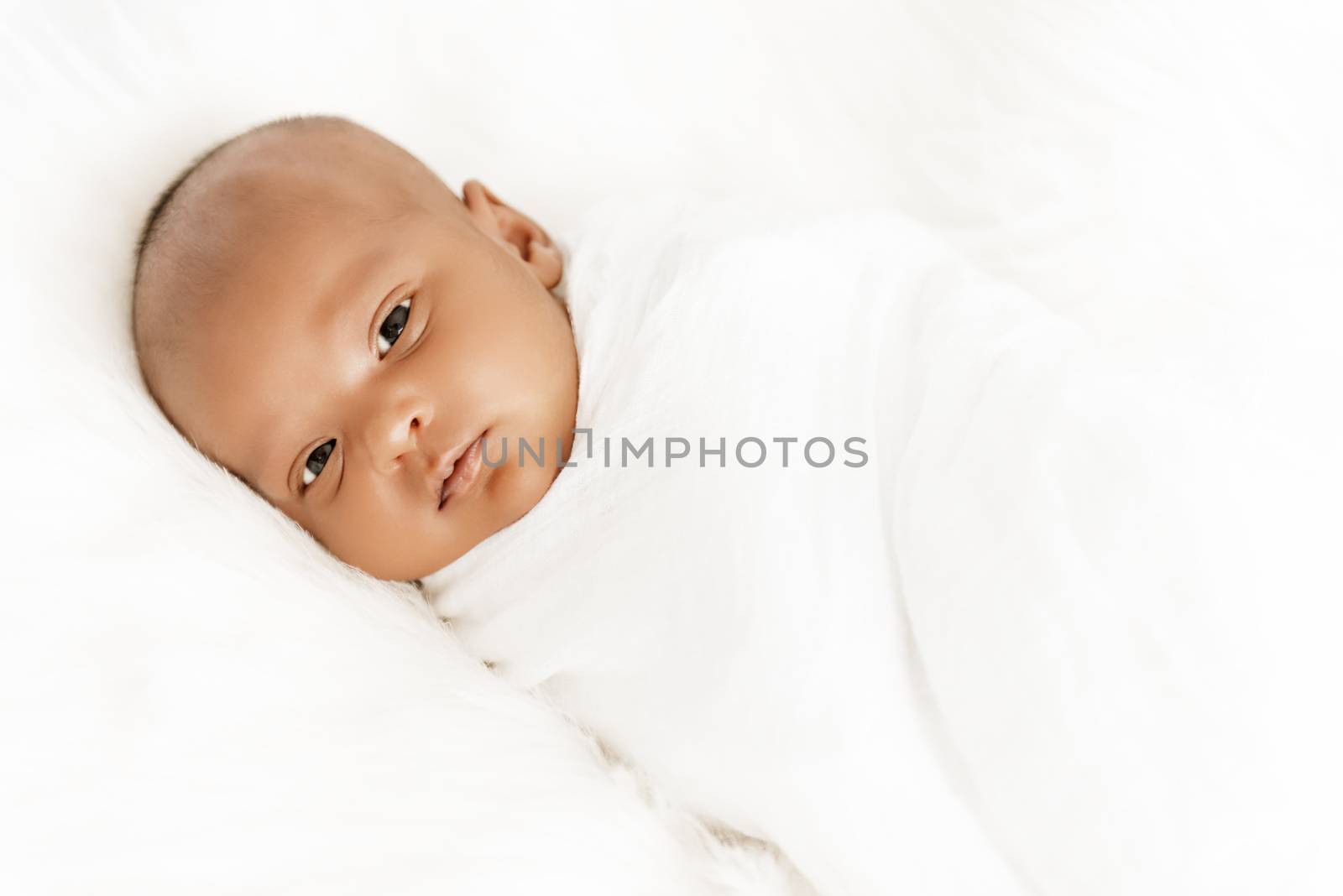 Three weeks old baby sleeping on white blanket cute infant newborn lying down close up shot eyes open by Altinosmanaj