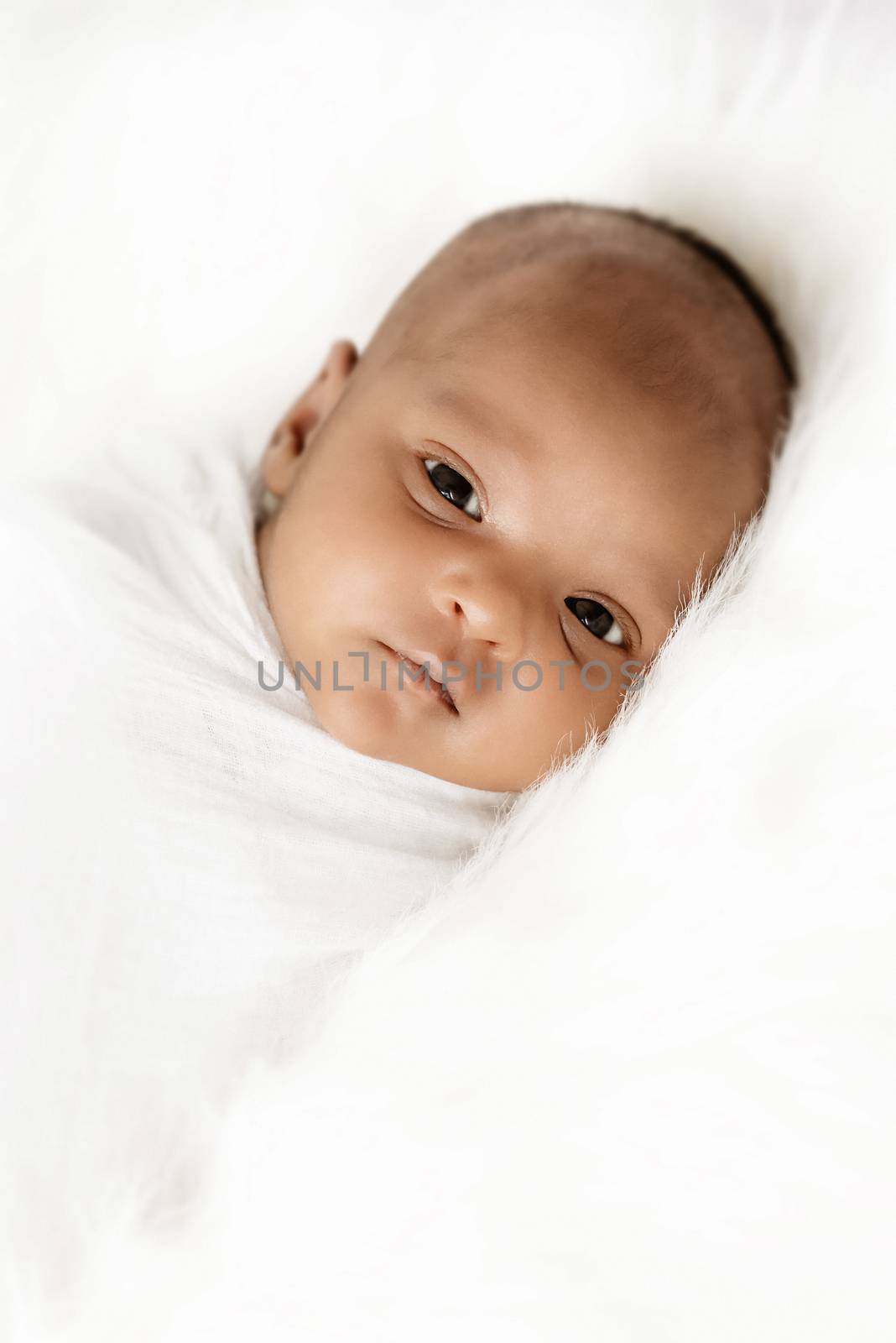 Three weeks old baby sleeping on white blanket cute infant newborn lying down close up shot eyes open by Altinosmanaj